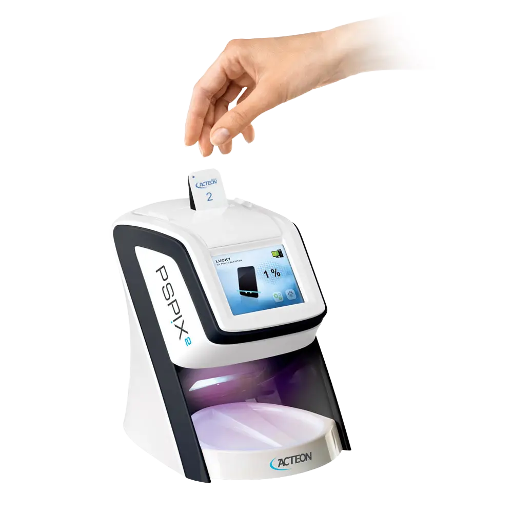 Imaging plate being inserted into an Acteon PSPIX2 scanner chairside