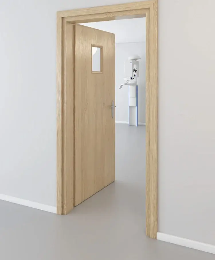 Light oak lead-lined X-ray door with vision panel, opening onto a CBCT room