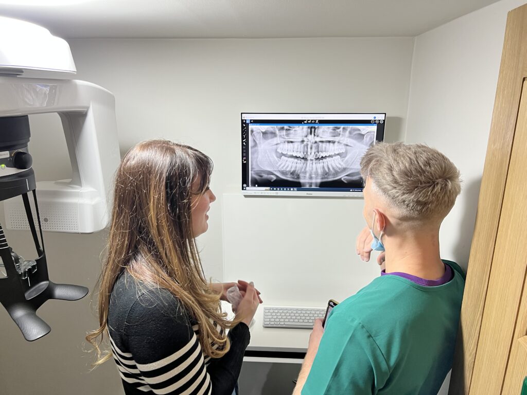 The team at Dentistry at Holme, West Yorkshire, reviewing a scan from their Carestream CS 8100 3D