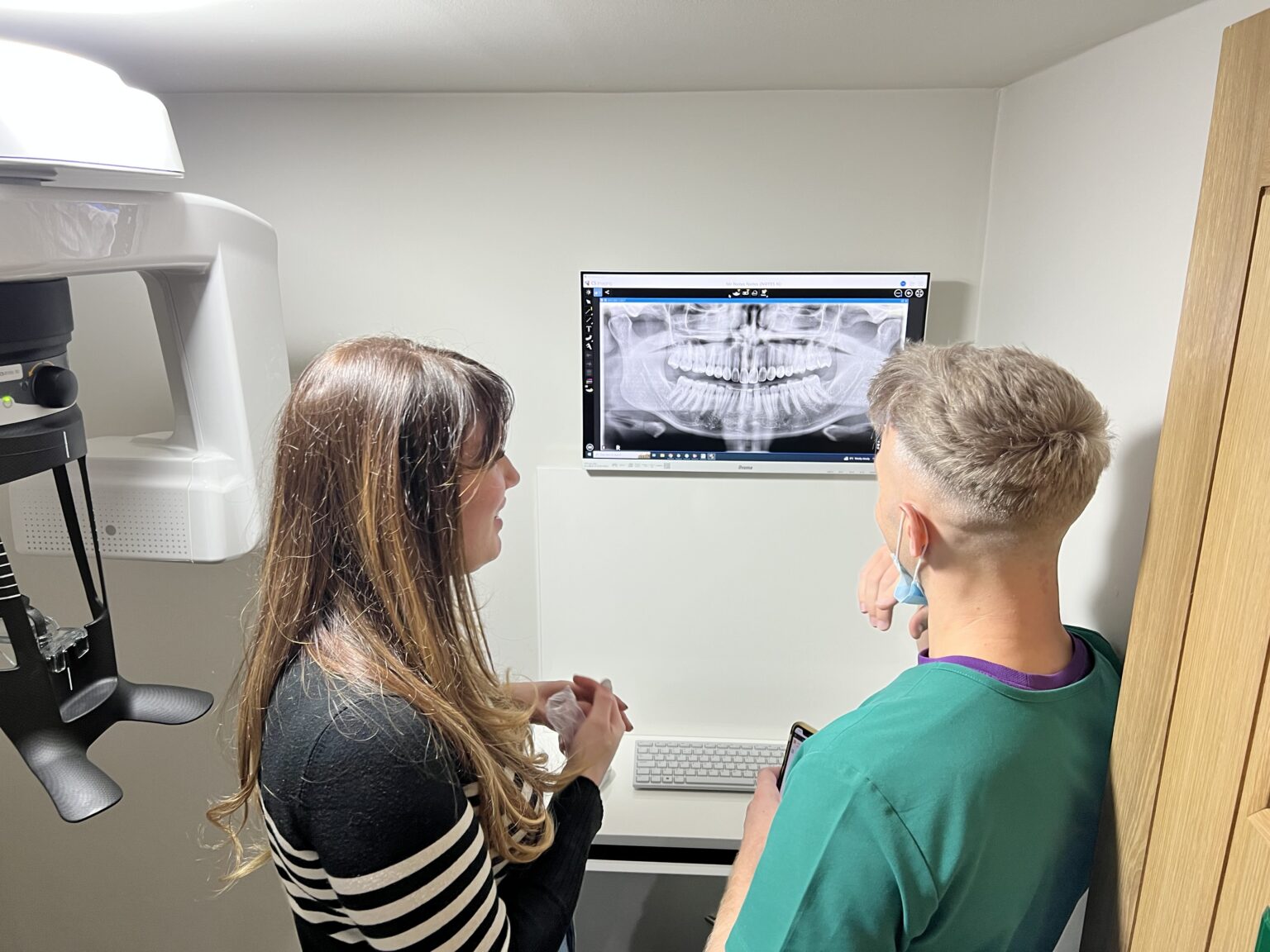 The team at Dentistry at Holme reviewing a panoramic scan from their Carestream CS 8100 3D