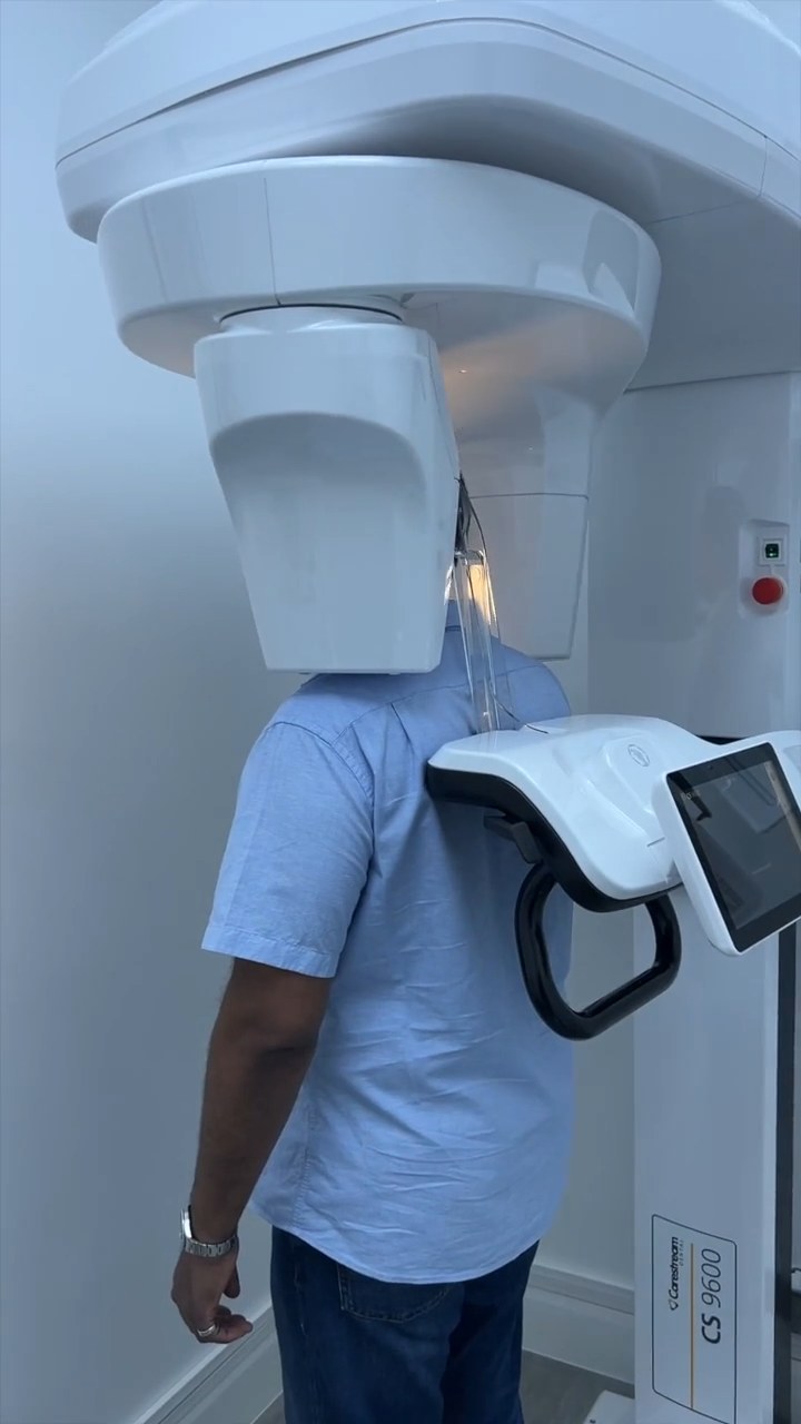 Prakash Promod standing in the Carestream CS 9600 for a 3D face scan