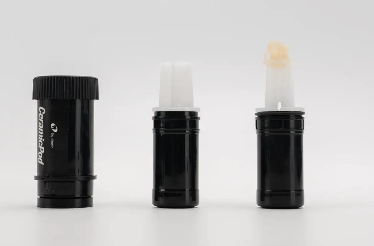 A sealed CeramicPod capsule, an opened capsule, and a capsule with a printed crown